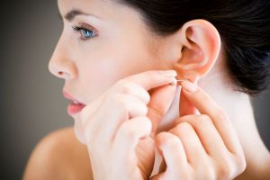 Woman-putting-in-earrings